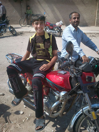 Boy on motorcycle, Azaz
